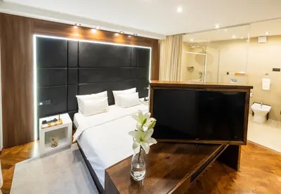 a hotel room with a large bed and a television at Onyx luxury apartments in Belgrade