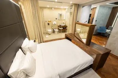 a bedroom with a large bed and a bathroom at Onyx luxury apartments in Belgrade