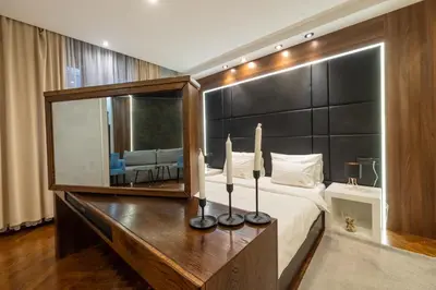 a bedroom with a large mirror and a bed at Onyx luxury apartments in Belgrade