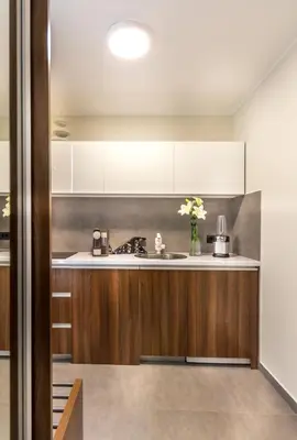 a kitchen with white cabinets and a sink at Onyx luxury apartments in Belgrade