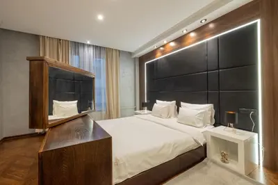 a bedroom with a large bed with a black headboard at Onyx luxury apartments in Belgrade