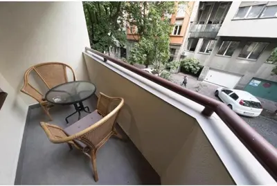 a balcony with chairs and a table and a window at Onyx luxury apartments in Belgrade