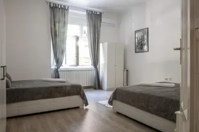 a bedroom with two beds and a window at Natalie's Apartment in Belgrade