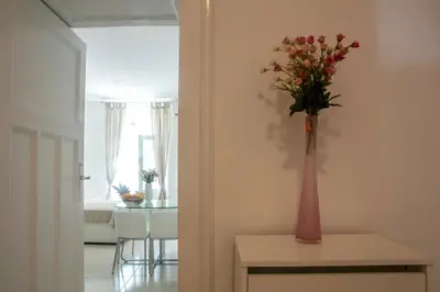 a vase of flowers on a table in a room at Natalie's Apartment in Belgrade