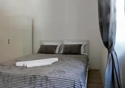 a bed with two white pillows on top of it at Natalie's Apartment in Belgrade
