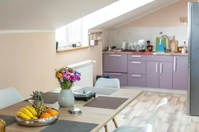 a kitchen with a table with a bowl of fruit on it at Wizard House Belgrade in Belgrade