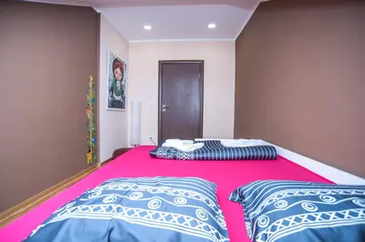 a bedroom with a large bed with two pillows at Wizard House Belgrade in Belgrade