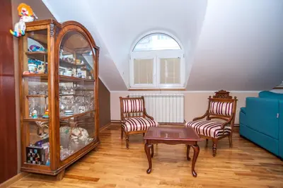 a living room with two chairs and a table at Wizard House Belgrade in Belgrade