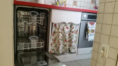 a kitchen with a dish drying rack and a dishwasher at Apartment Resavska in Belgrade