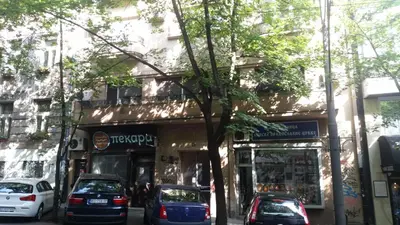 a street with cars parked in front of a store at Apartment Resavska in Belgrade