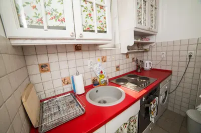 a kitchen with a sink and a red counter top at Apartment Resavska in Belgrade