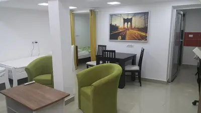 a room with a table and chairs and a dining room at Apartment 18 in Pančevo