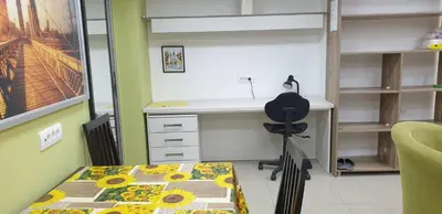 a room with a desk and a table with a chair at Apartment 18 in Pančevo