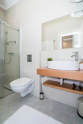a bathroom with a toilet and a sink and a shower at Royal park in Belgrade