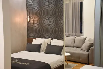 a bedroom with a bed and a couch at Royal park in Belgrade