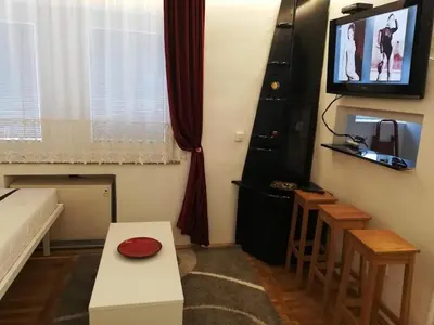 a small living room with a tv and a table at Lola 1 in Belgrade