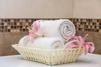 a basket filled with towels and flowers on a counter at Belgrade Downtown Residence in Belgrade