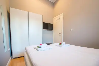 a bedroom with a white bed with towels on it at Belgrade Downtown Residence in Belgrade