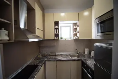 a kitchen with a sink and a microwave at Central Park Lux in Arandjelovac