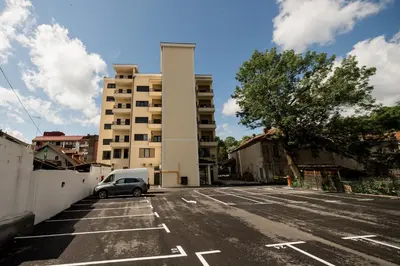 a car parked in a parking lot in front of a building at Central Park Lux in Arandjelovac
