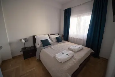 a bedroom with a bed with towels on it at Central Park Lux in Arandjelovac