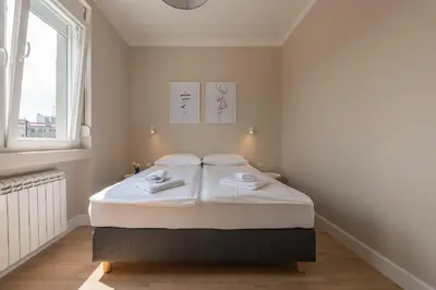 a white bedroom with a bed in a room at Urban ZEN with View - City Break Apartments in Belgrade