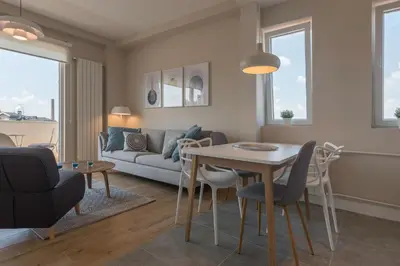 a living room with a table and a couch at Urban ZEN with View - City Break Apartments in Belgrade