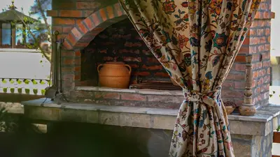 a brick fireplace with a curtain in front of it at Dunavska Kuća in Smederevo