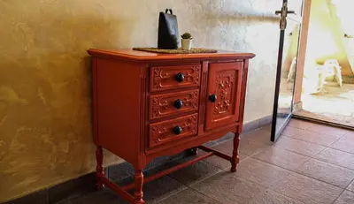 a wooden dresser with a black bag on top of it at Dunavska Kuća in Smederevo