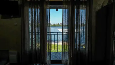 a room with a window with a view of the water at Dunavska Kuća in Smederevo