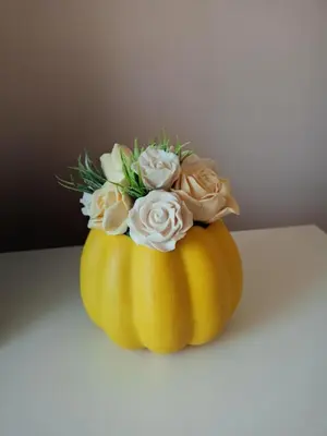 a bouquet of flowers sitting in a pumpkin at Apartment Andjela in Belgrade