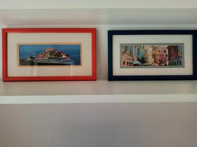 three framed pictures hanging on a wall at Apartment Andjela in Belgrade