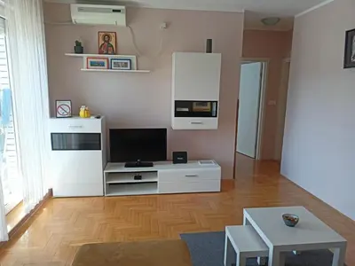 a living room with a television and a white entertainment center at Apartment Andjela in Belgrade
