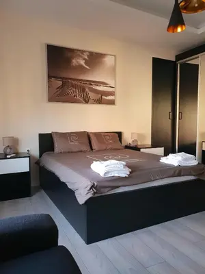 a bedroom with a large bed with two towels on it at Z&N luxury Belgrade appartment - city center in Belgrade