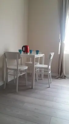 a white table and chairs in a room at Z&N luxury Belgrade appartment - city center in Belgrade