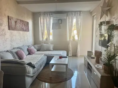 a living room with a couch and a table at Prenočište Dunav in Novi Banovci