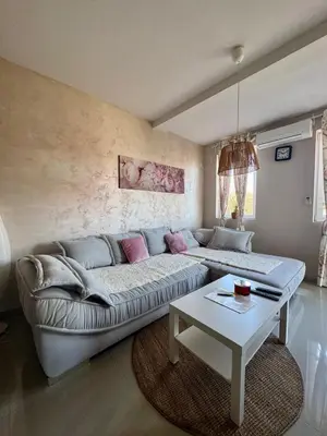 a living room with a couch and a table at Prenočište Dunav in Novi Banovci