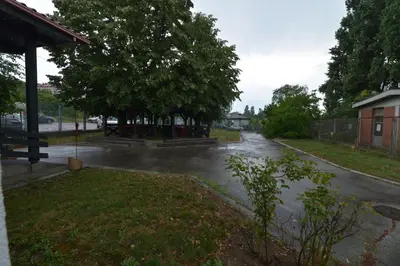 a flooded street with trees and a building at Guesthouse Duga in Belgrade