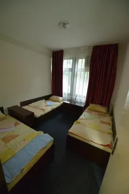 a room with three beds and a window at Guesthouse Duga in Belgrade
