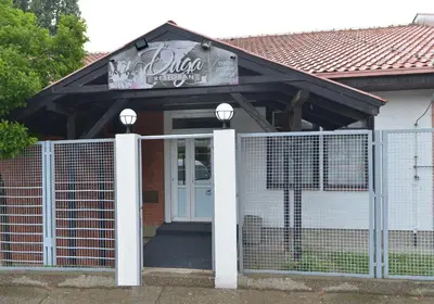 a house with a gate with a sign on it at Guesthouse Duga in Belgrade