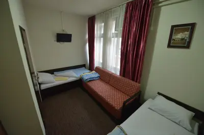 a room with a couch and a chair and a window at Guesthouse Duga in Belgrade