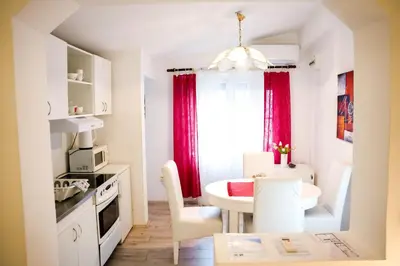 a small kitchen and dining room with a table at Gardos in Belgrade