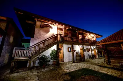 an old house with a staircase on the side of it at Srpsko Andrejevo Selo in Belgrade