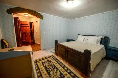 a bedroom with a bed in a room with blue walls at Srpsko Andrejevo Selo in Belgrade