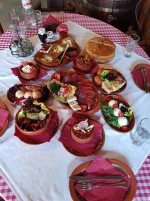 a table topped with plates of food on a table at Srpsko Andrejevo Selo in Belgrade