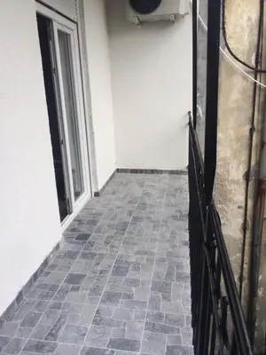 a hallway with a tile floor and a fence at H&M Lux appartment downtown NEW in Belgrade
