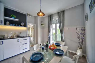 a kitchen with a table and chairs and a dining room at H&M Lux appartment downtown NEW in Belgrade
