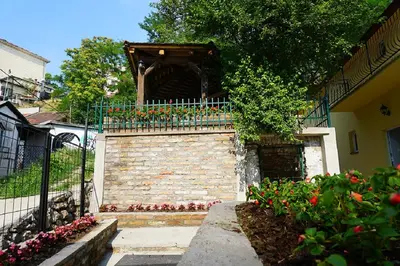 a building with a balcony with flowers on it at Male stepenice in Belgrade