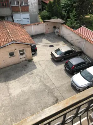 an aerial view of two cars parked in a parking lot at Cozy studio Belgrade (Zemun) in Belgrade