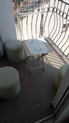 a balcony with a bench and two chairs and a table at Cozy studio Belgrade (Zemun) in Belgrade